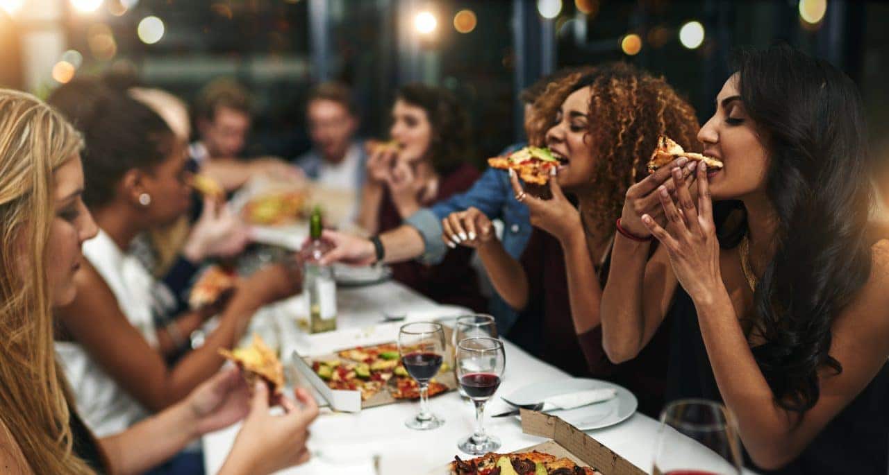 People enjoying pizza in a restaurant