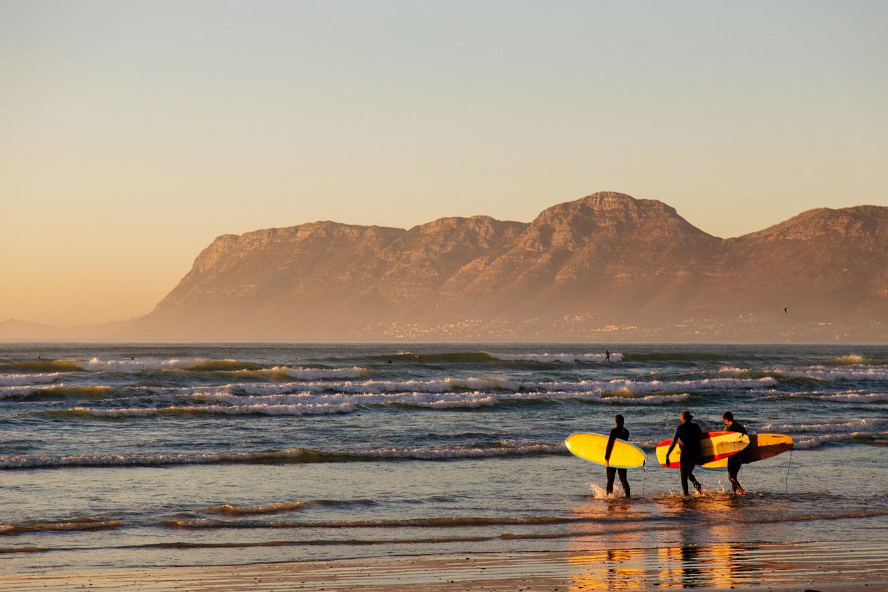surfers head to the water