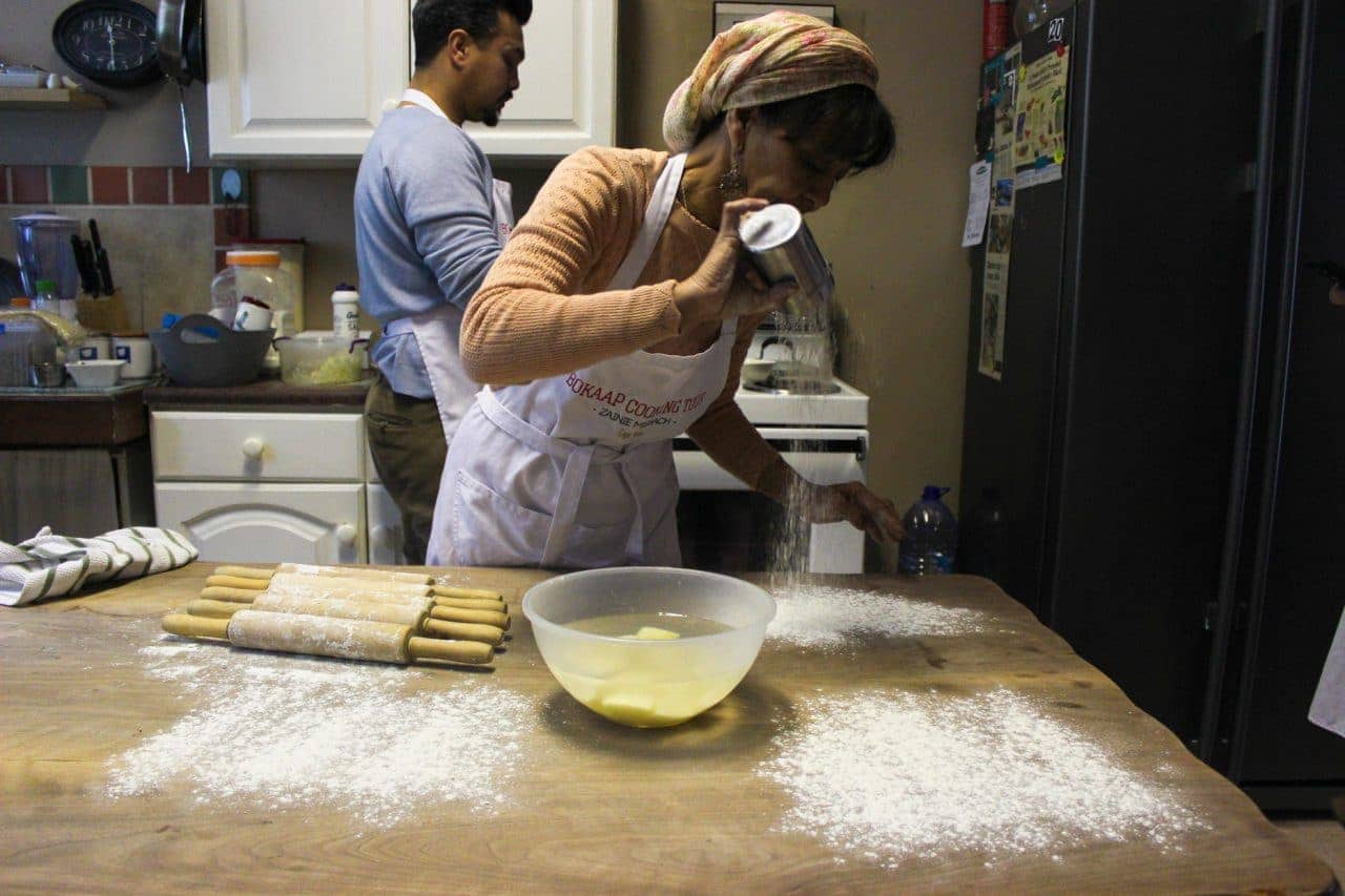 Zainie Misbach pours flour on a table on the Bo-Kaap cooking tour