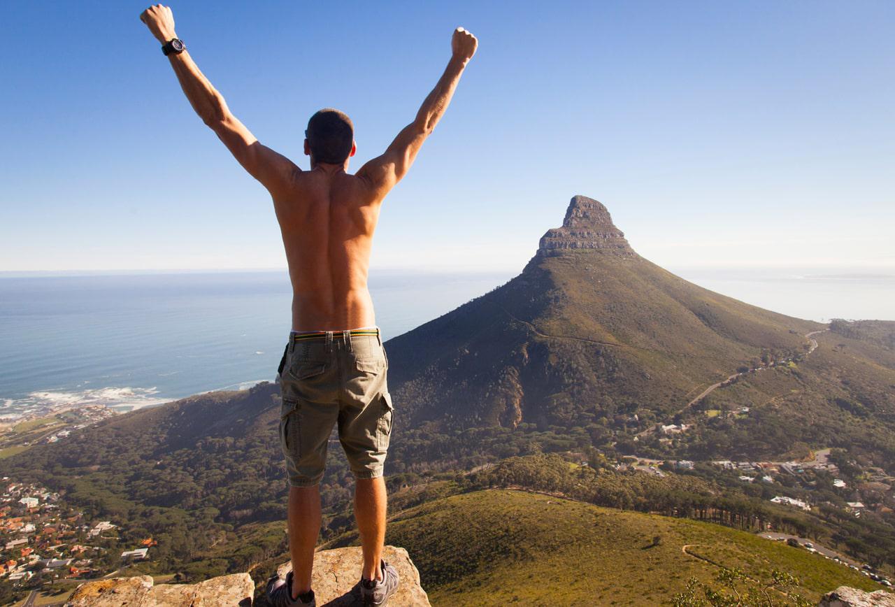 hiker_without_shirt_on_top_of_table_mountain