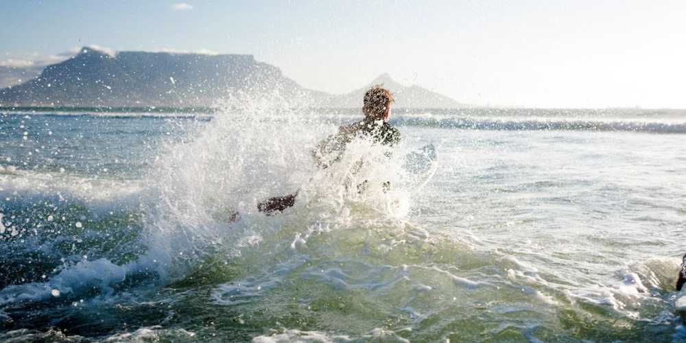 Surfer Breaking Waves in the Ocean Cape Town