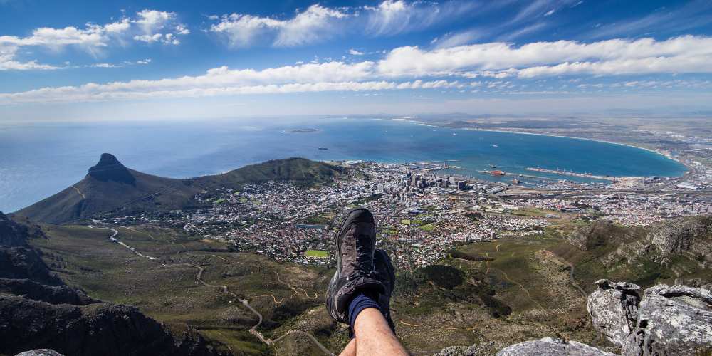 Hiker sitting on top of Table Mountain, Cape Town